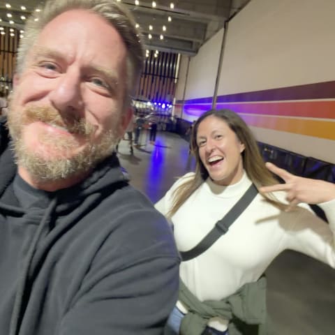 Geoff and Jenn smiling on a night out